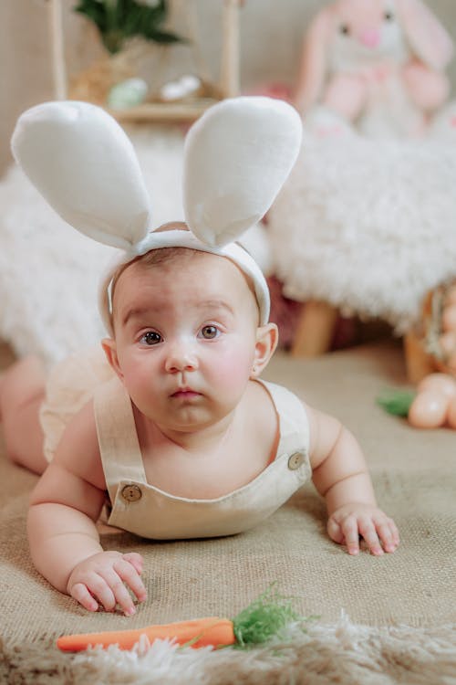A Baby Wearing Bunny Ears for an Easter Photoshoot 