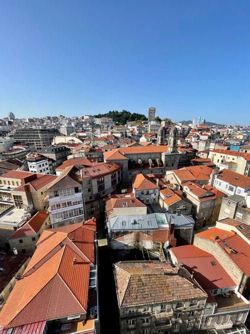 Free A captivating aerial view showcasing the charming rooftops of historic Vigo, Spain under a clear blue sky. Stock Photo