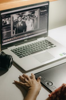 A person processes wedding photos on a laptop using a graphics tablet, showcasing digital editing tools.