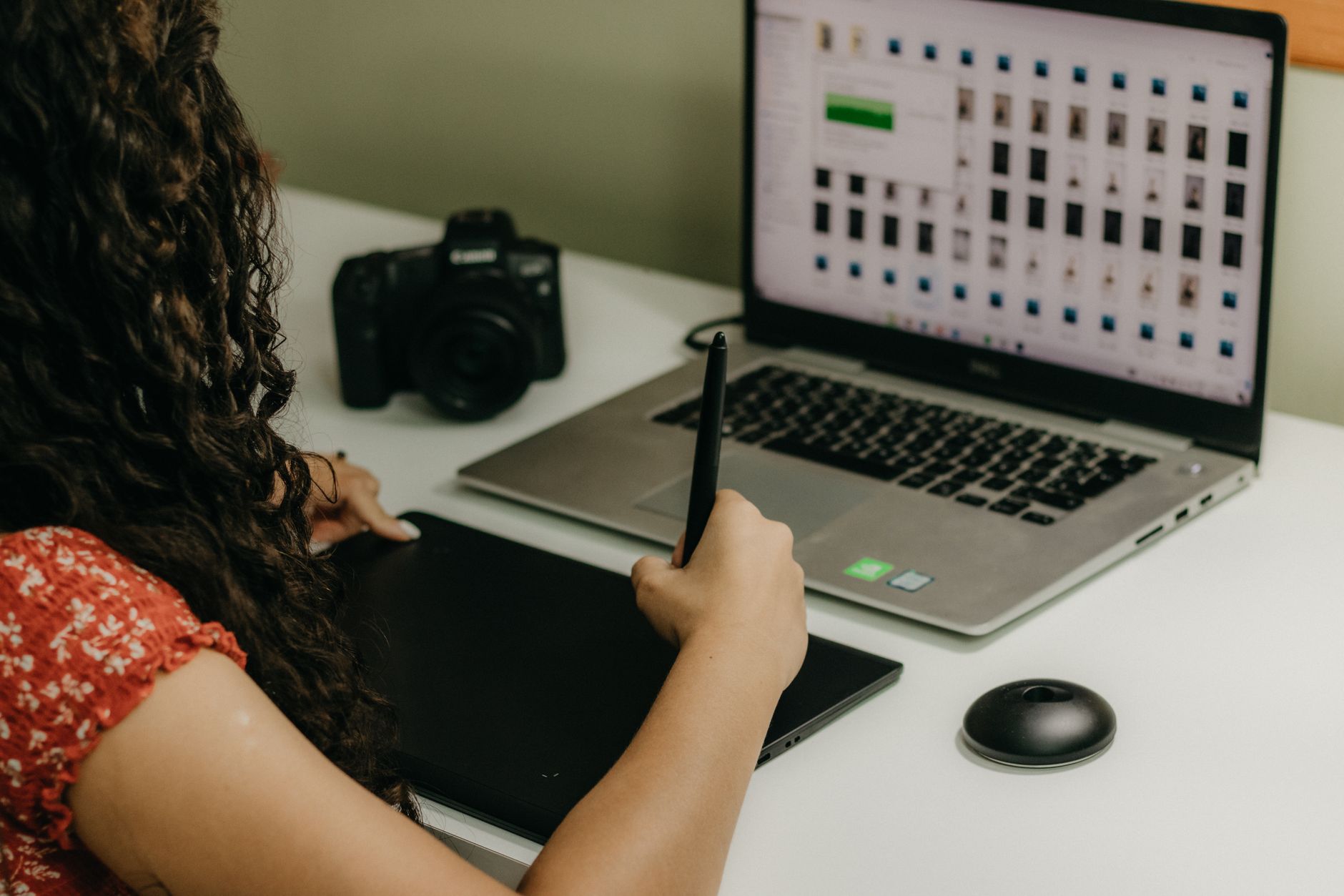 Creator reviewing and editing blog visuals at a laptop desk