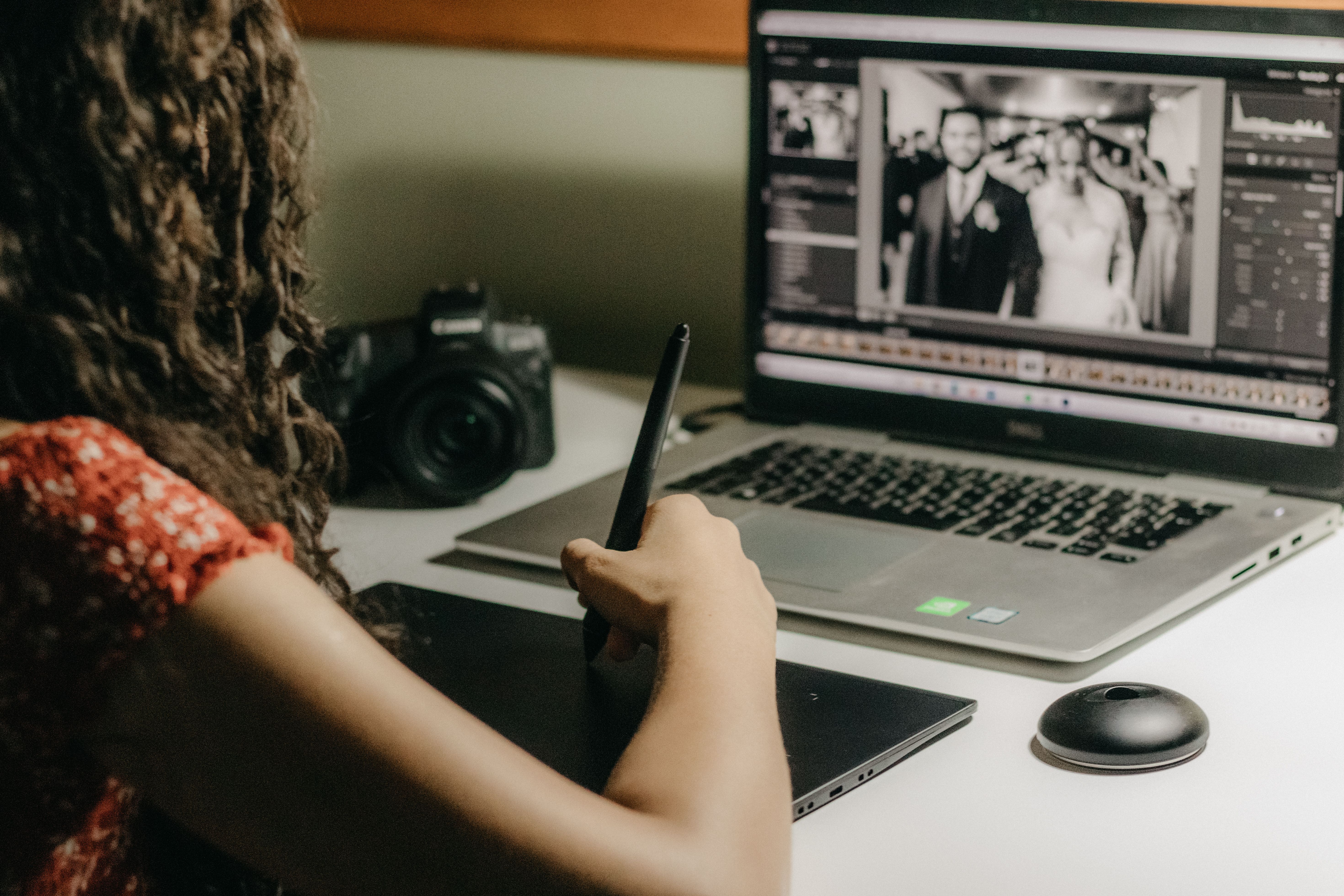 A woman is using her laptop to take pictures · Free Stock Photo