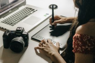 Artist creating digital art on a graphics tablet — photo by Kawe Rodrigues on Pexels