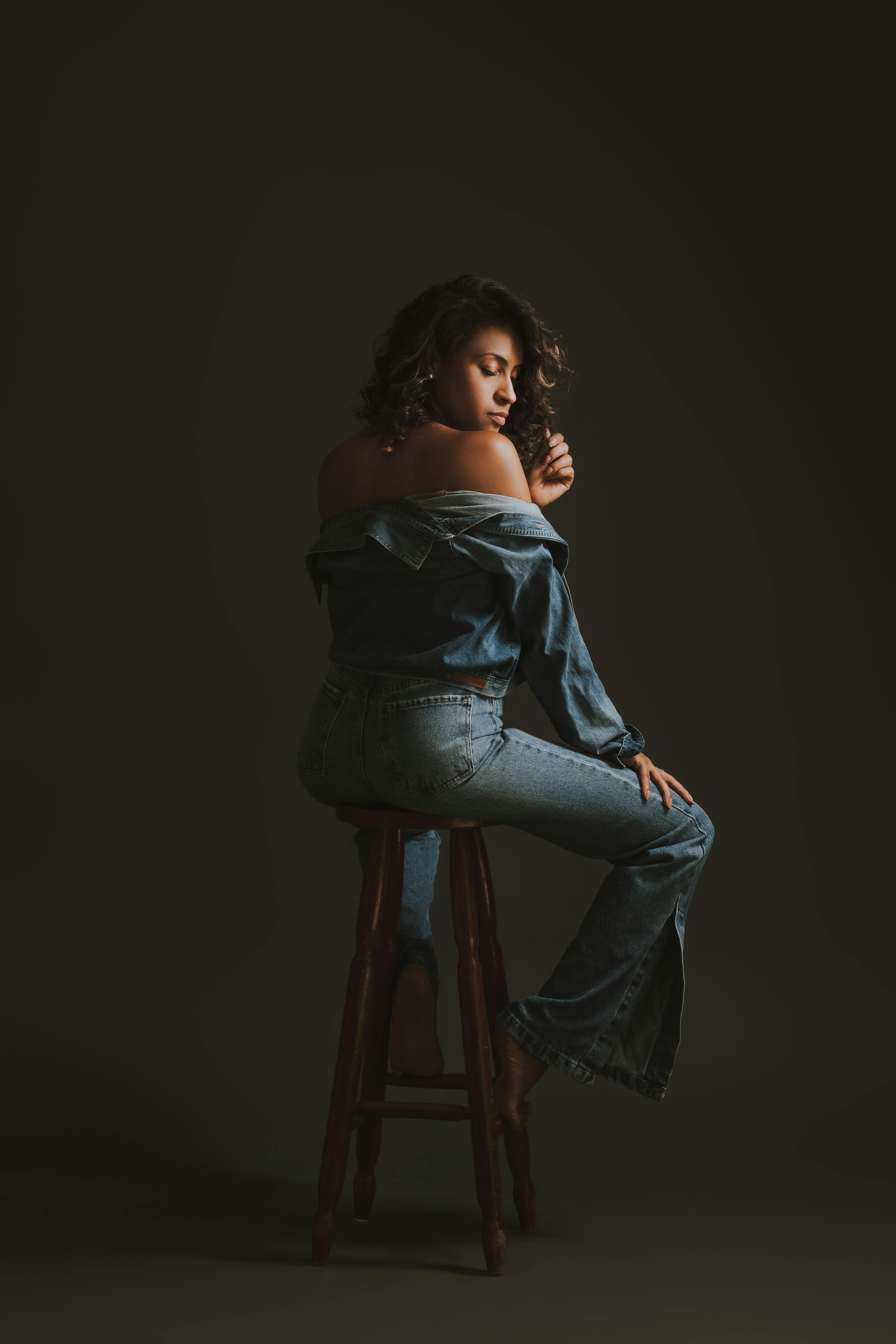 free photo of back view of a woman sitting on a stool