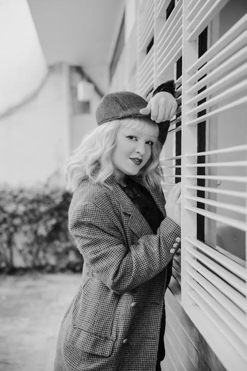 Portrait of a Female Model Leaning on Window Security Bars