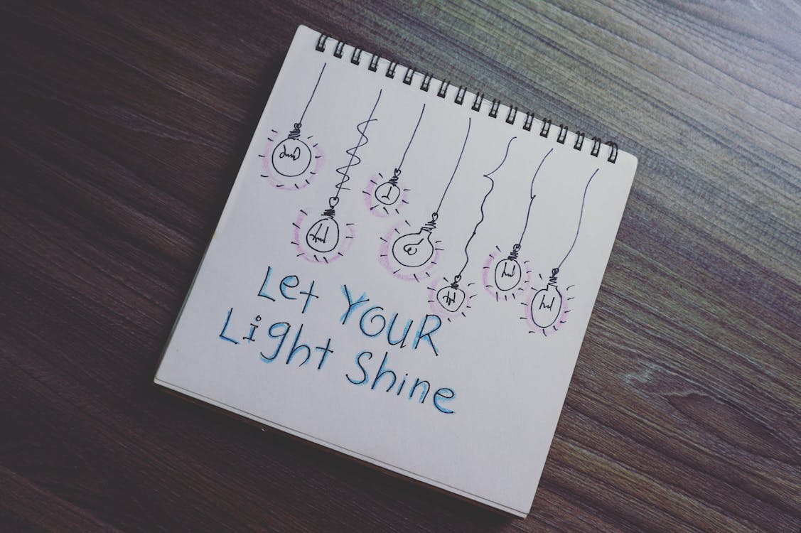 Free Let Your Light Shine Drawing on Notebook Stock Photo