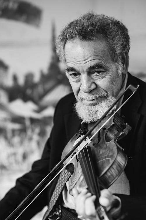 Free Grayscale Photography of Man Playing Violin Stock Photo