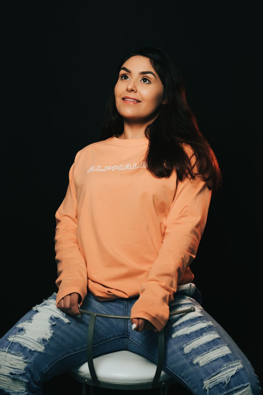 A crewneck sweatshirt worn on the body, crew rib and set-in sleeve visible