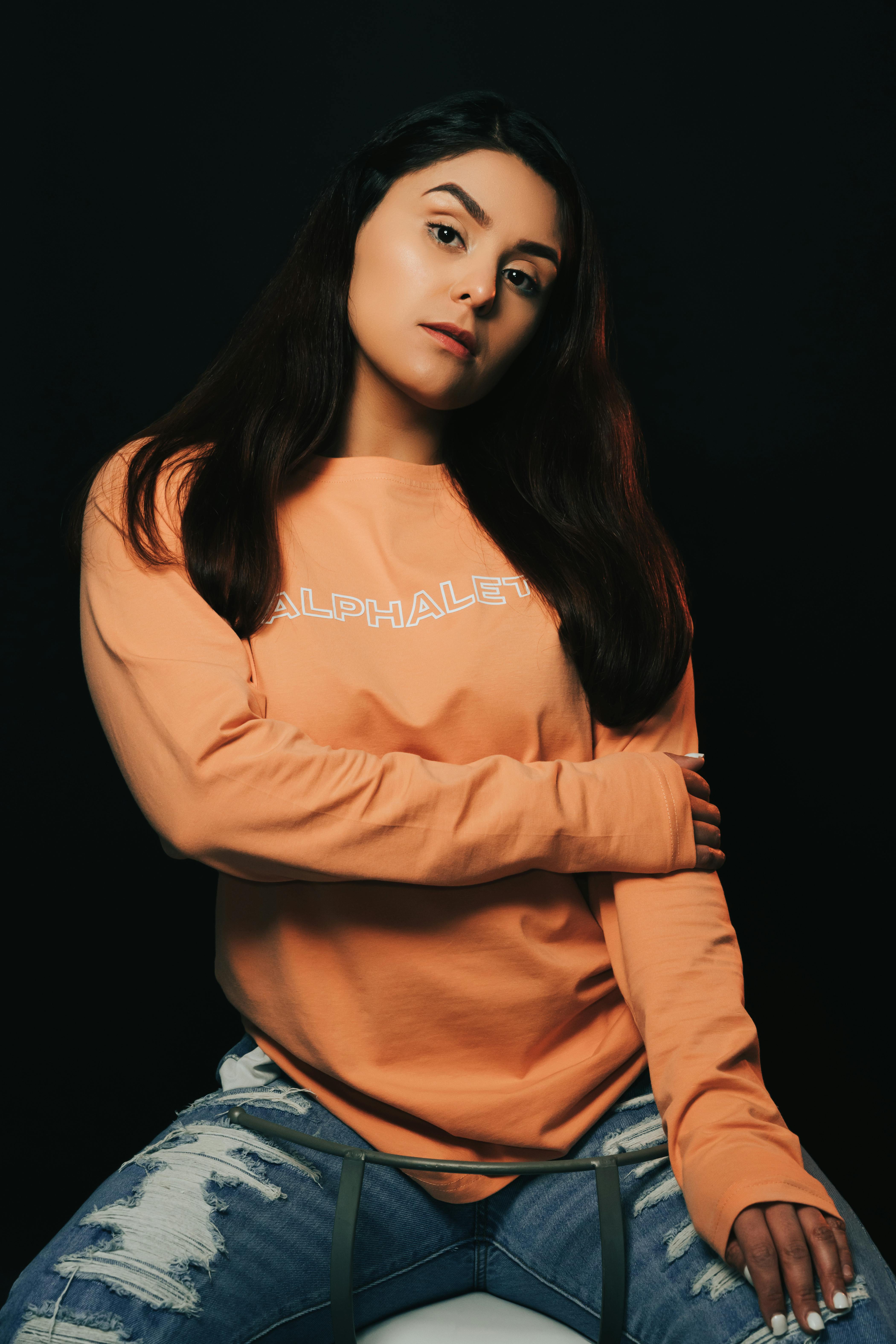 A stylish person wearing a black sweatshirt, making a fashion statement
