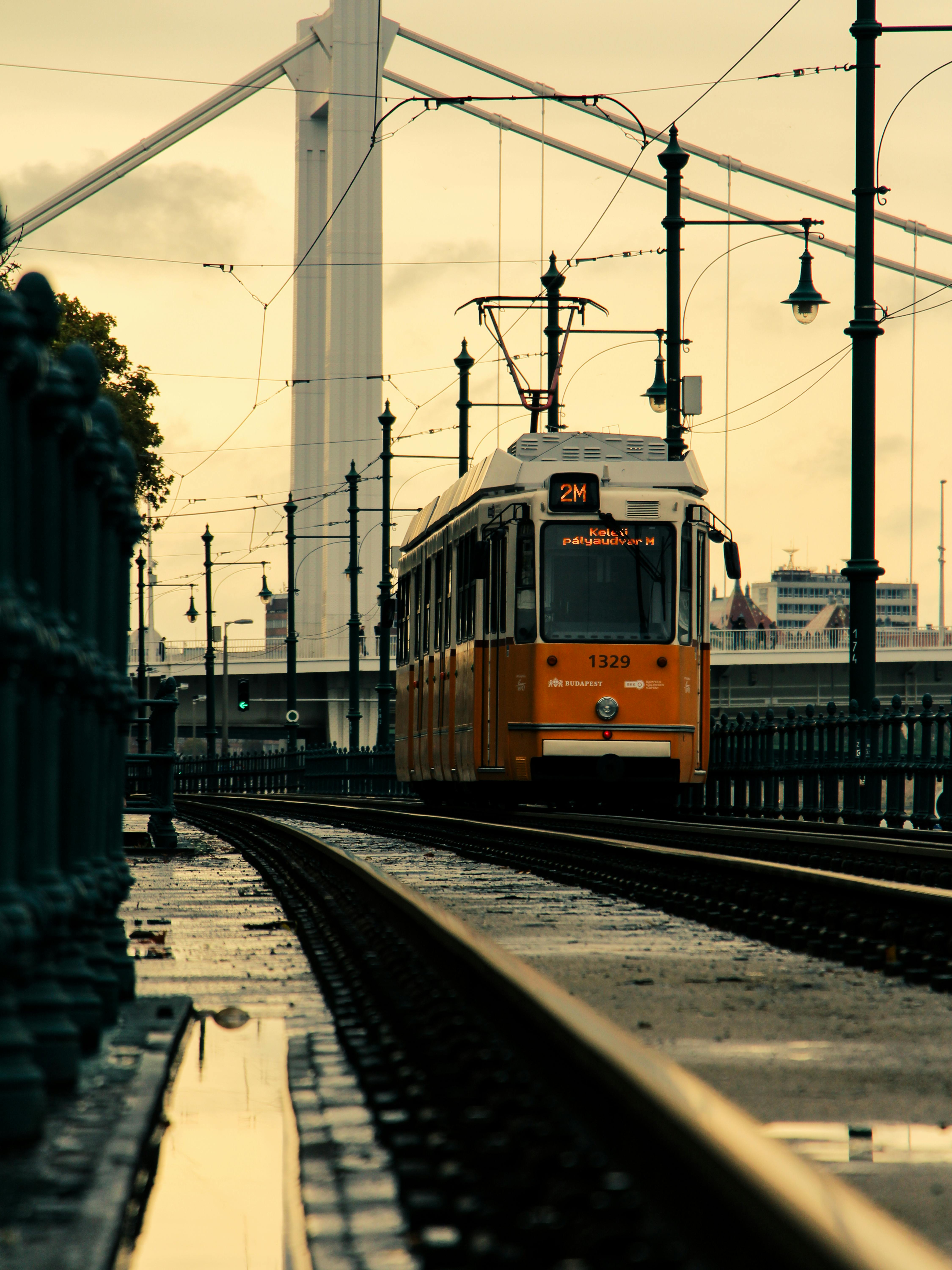 orange-tram-passing-near-elisabeth-bridge-in-budapest-free-stock-photo