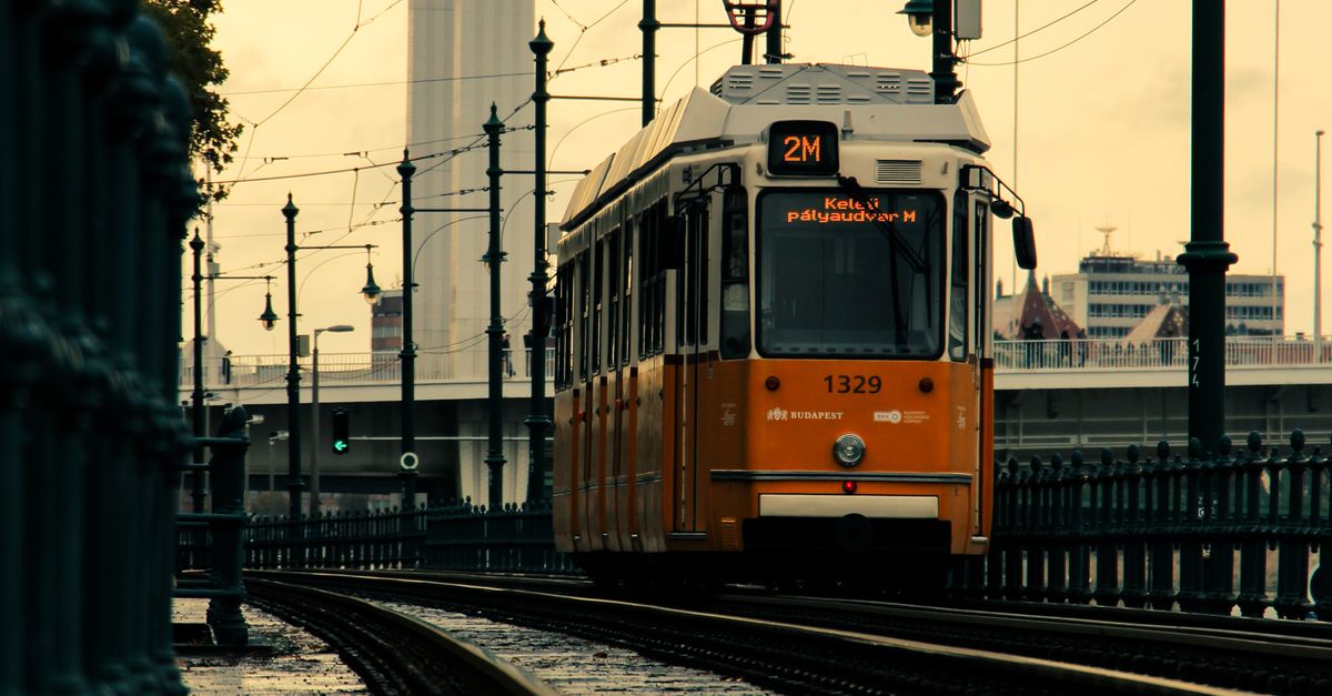 Orange Tram Passing Near Elisabeth Bridge In Budapest Free Stock Photo orange-tram-passing-near-elisabeth-bridge-in-budapest-free-stock-photo