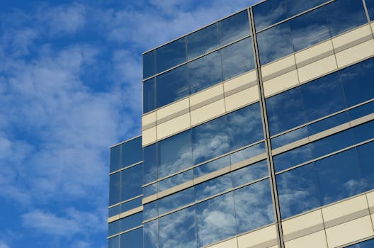 A striking glass building reflecting the sky, showcasing modern architecture.