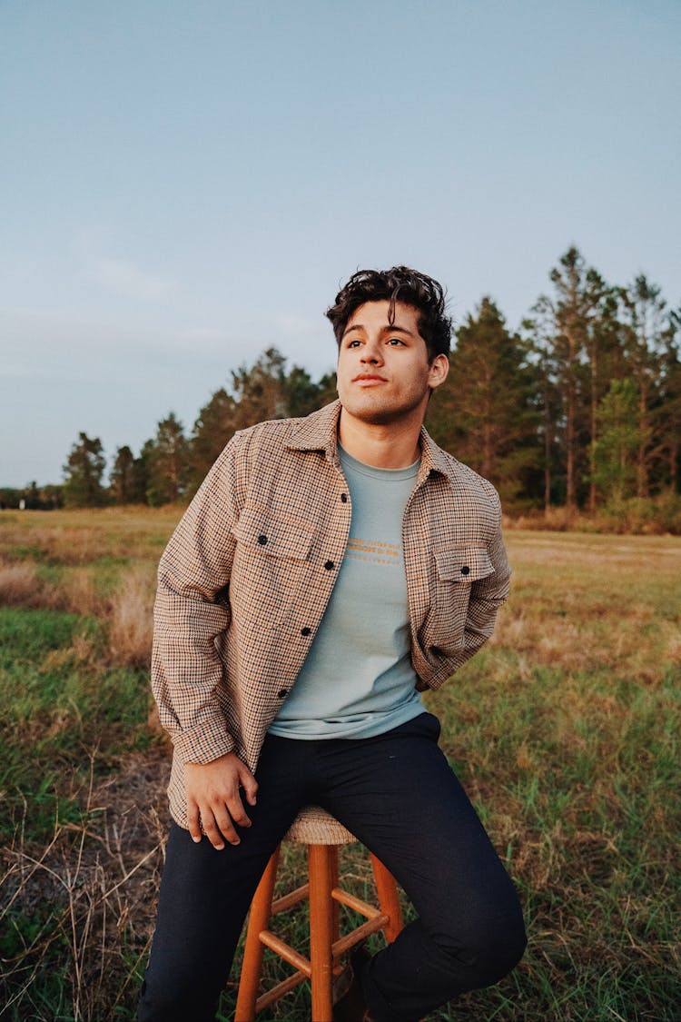 Man Posing On Chair On Field