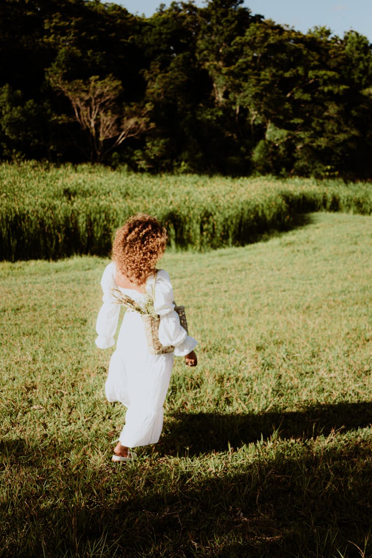 Woman Walking On Meadow