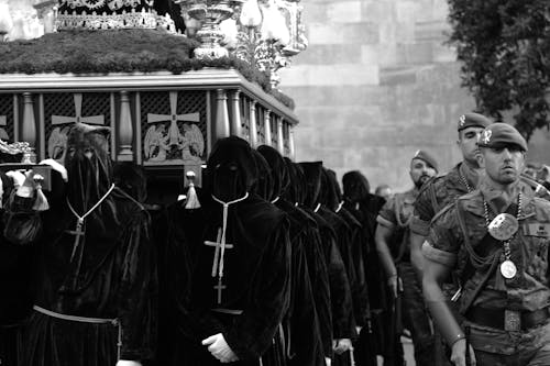 People in Hoods on Religious Ceremony Outdoors