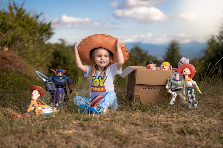 Girl In Hat Sitting With Toys