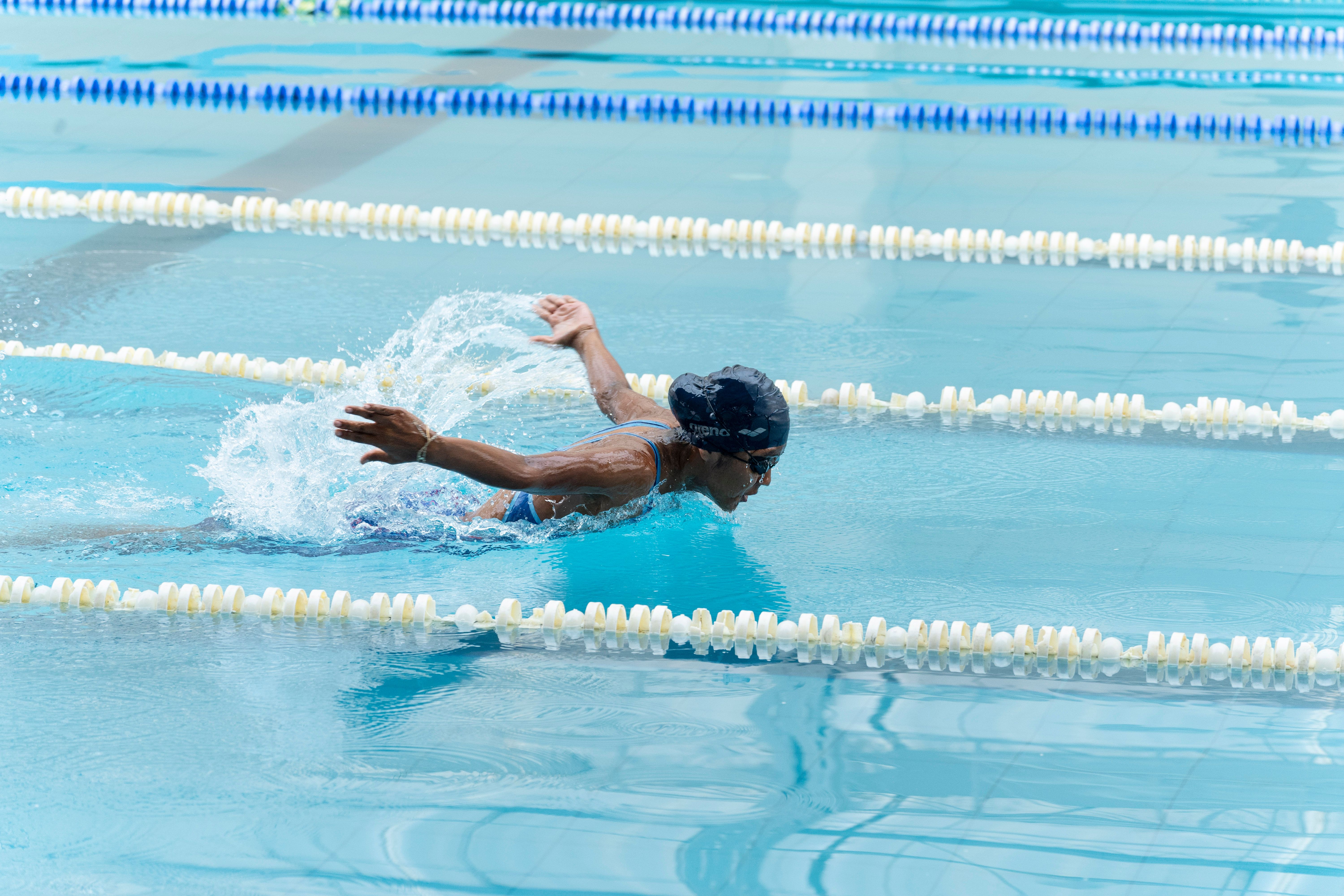 Person Swimming on Body of Water Doing Freestyle Strokes · Free Stock Photo