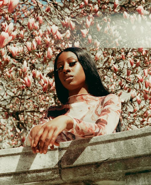 A woman with long hair and pink flowers on her head