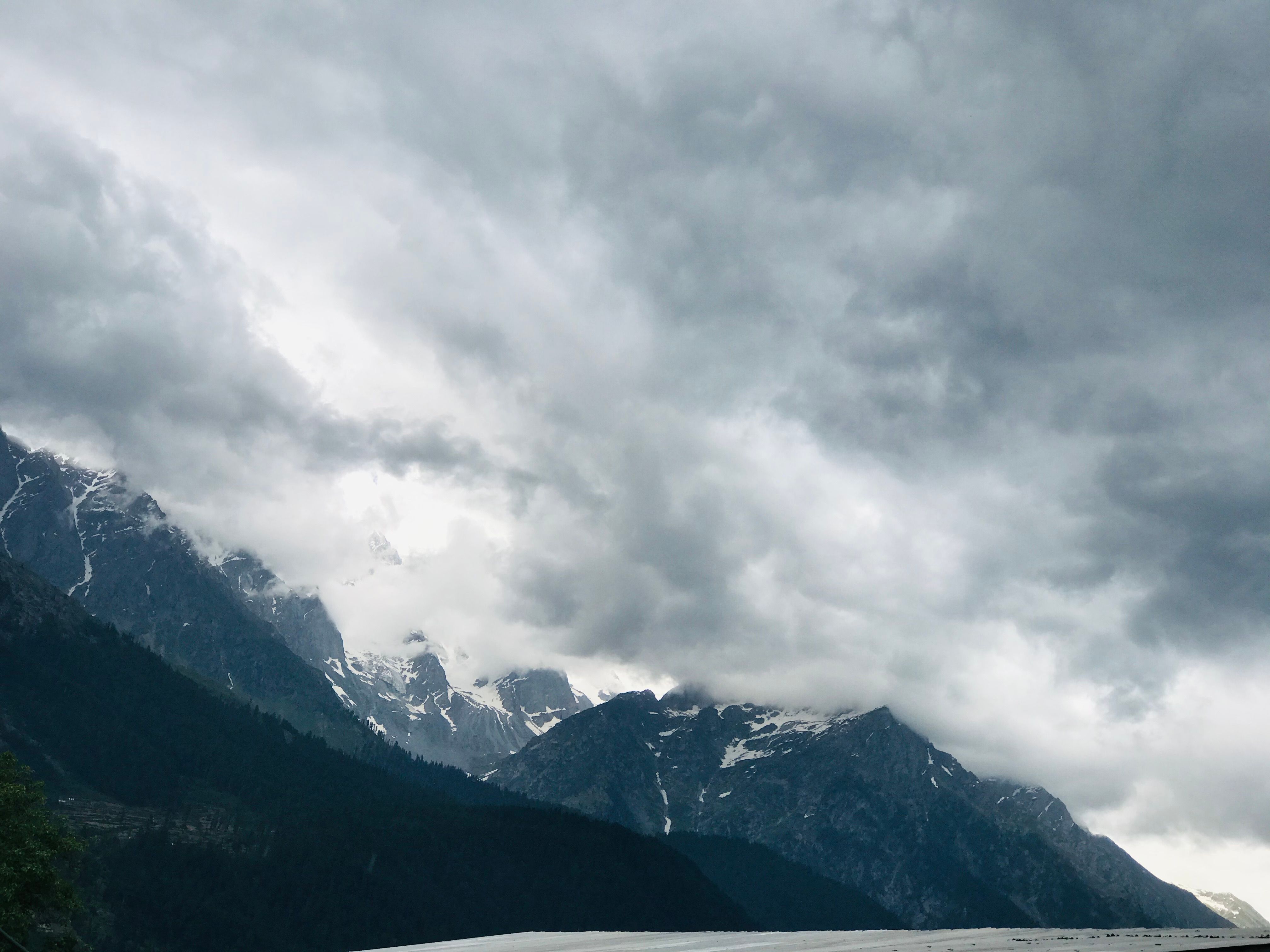 Rain Clouds over Steep Mountains · Free Stock Photo