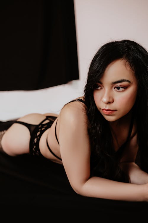Young Woman in Black Lingerie Lying on the Bed 