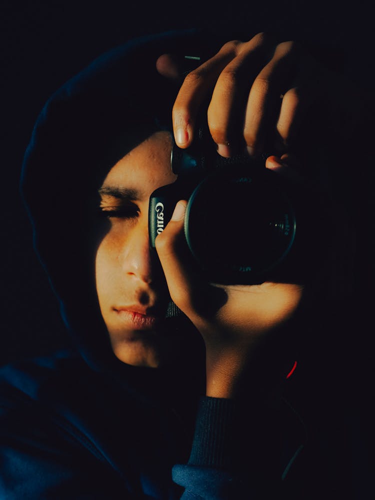 Man Holding Canon Camera Taking Photo