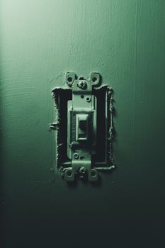 Detailed focus on an old light switch against a dark background, showcasing age and wear.