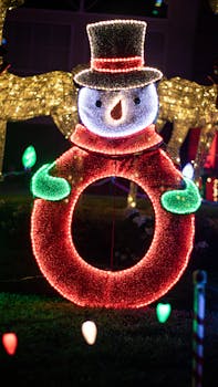 Colorful illuminated snowman decoration at night, perfect for holiday displays.