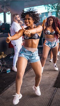 Vibrant outdoor dance performance featuring energetic women in stylish outfits, enjoying the music.