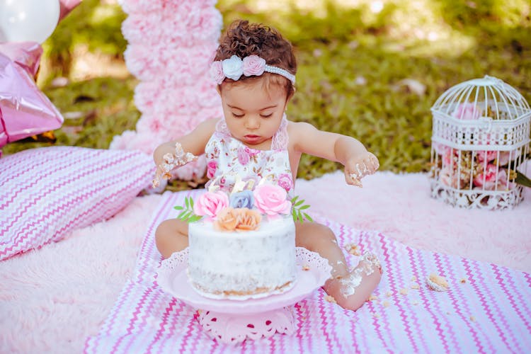 Girl With Birthday Cake In Garden