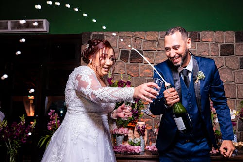 Newlywed Couple with Bottle of Champagne