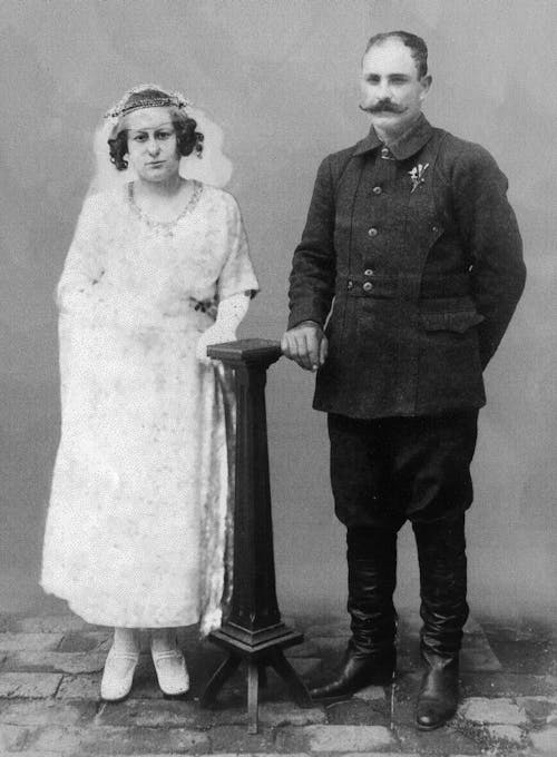 A Vintage Black and White Photograph of Bride and Groom in a Military Uniform 