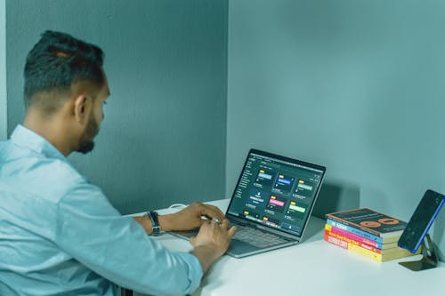 Man Working on Laptop at Home Office