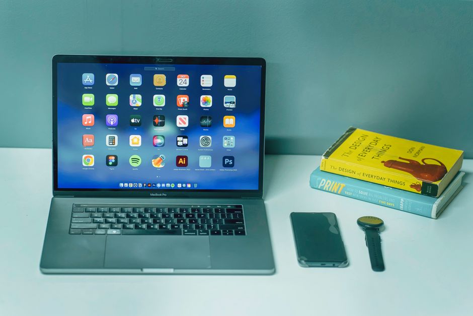 Brave vs Firefox vs Tor: Which Privacy Browser Stops Tracking Best? A sleek desk setup featuring a laptop, smartphone, watch, and books for a productive workspace.