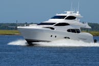 一艘现代化的豪华游艇在蔚蓝天空下平静的河面上快速航行