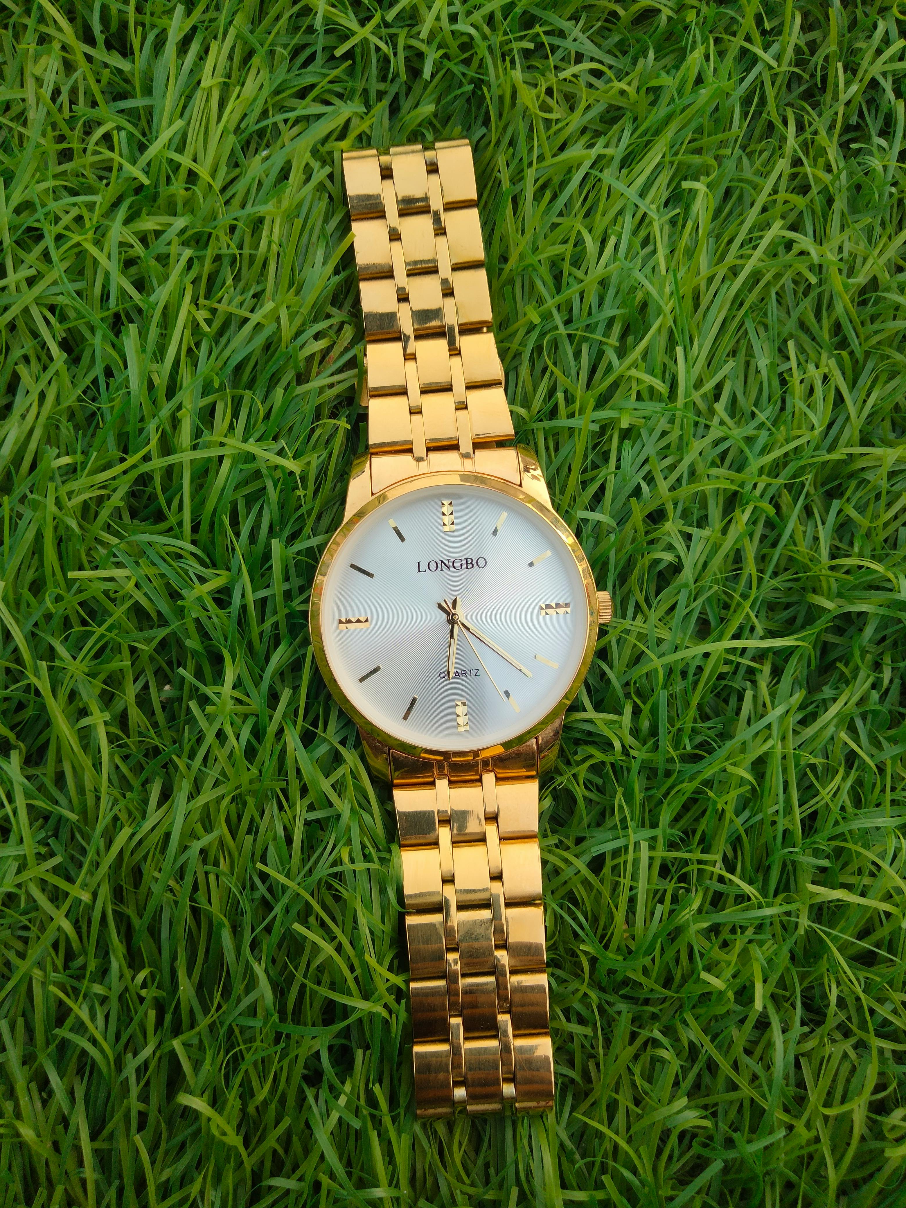 Golden Wristwatch on Green Grass · Free Stock Photo