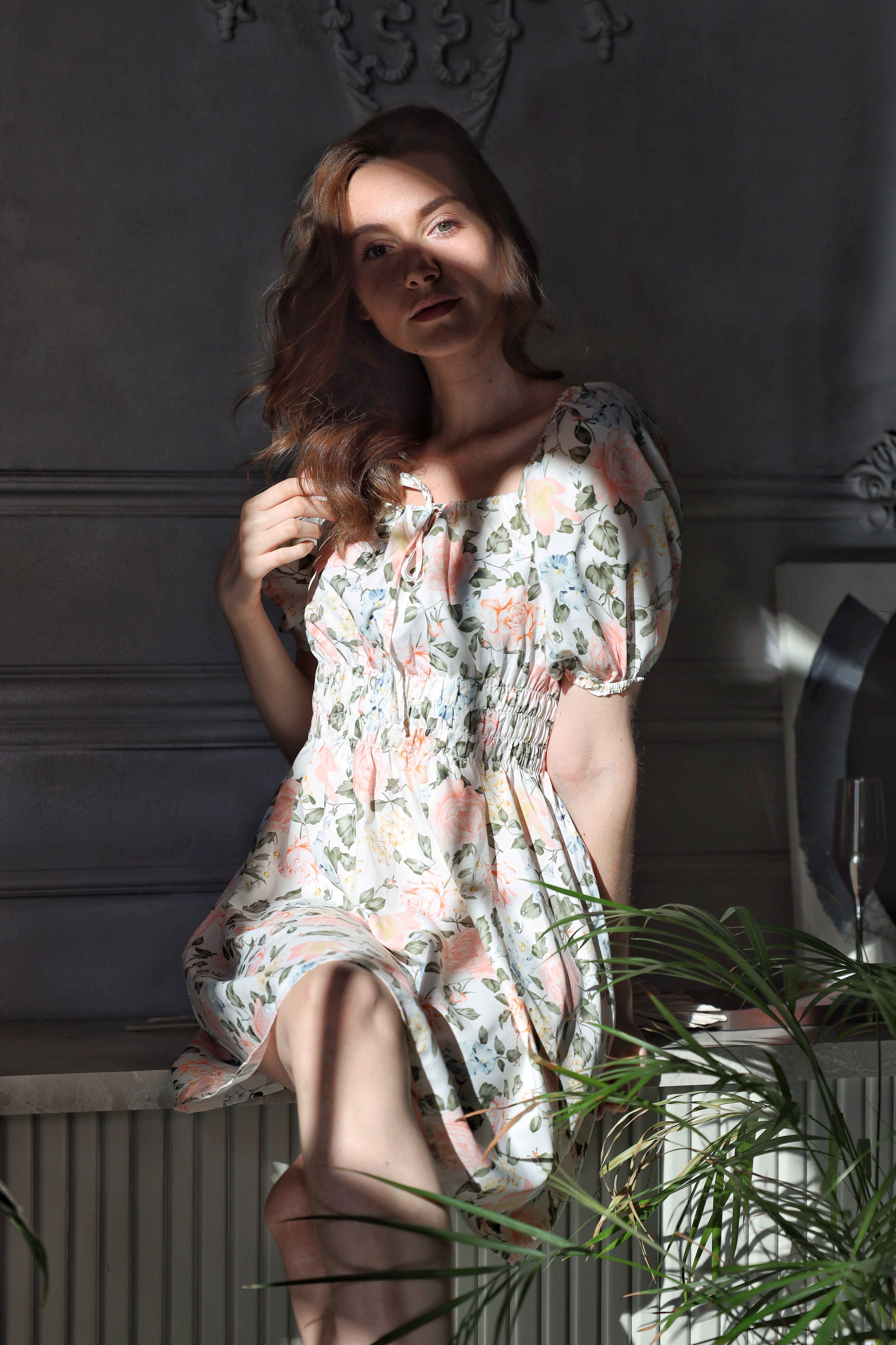 Young Woman in a Floral Dress Sitting in the Sunlight · Free Stock Photo