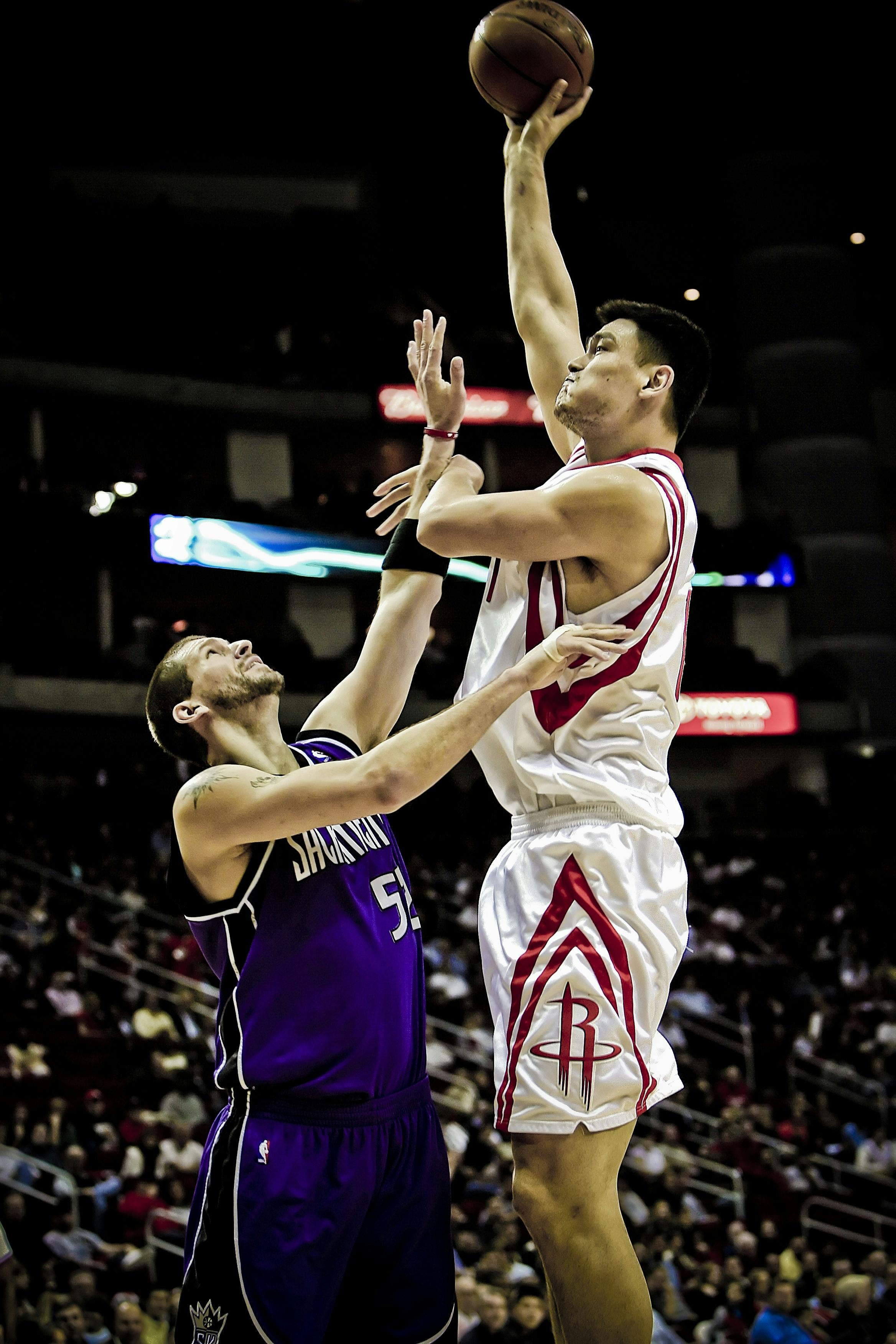 Yao Ming Holding Basketball On His Left Hand While Jumping Free