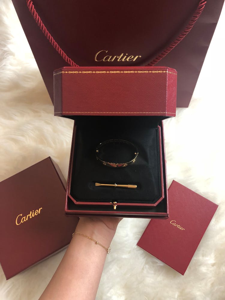 Woman Holding A Box With Cartier Jewelry 