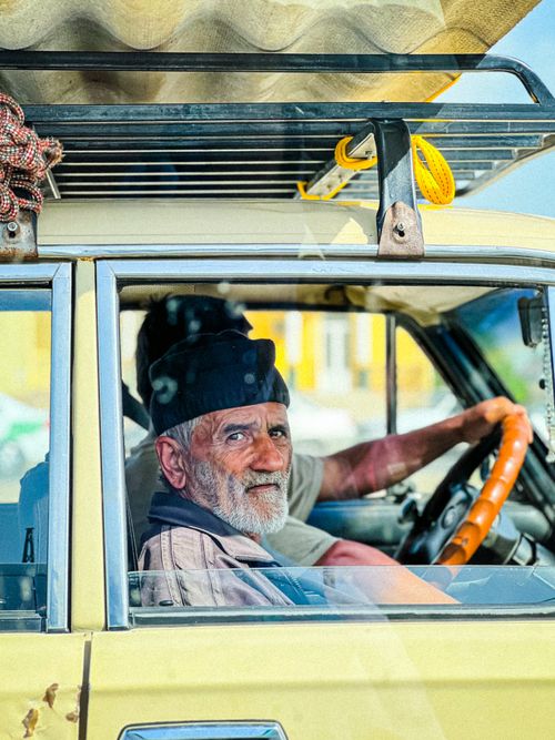 Free Elderly man captured driving a vintage car in Samarkand, Uzbekistan. Stock Photo