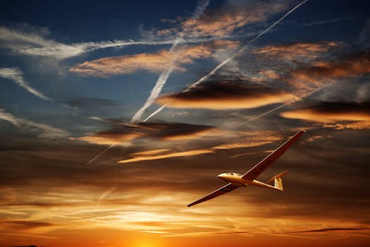A glider soaring gracefully against a dramatic sunset, capturing the essence of flight and serenity.