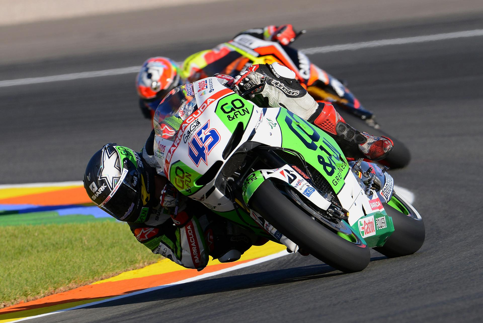 Two Motorcycle Racers Turning at Corner