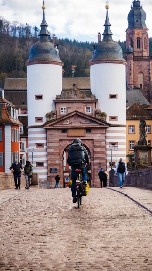Free A cyclist rides across the iconic Old Bridge in Heidelberg, Germany. Stock Photo