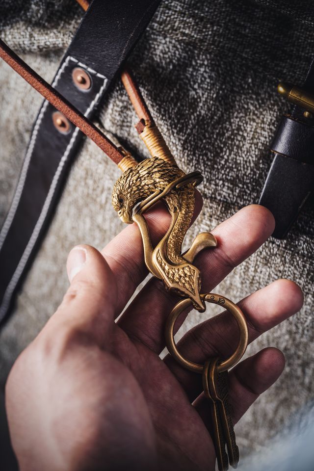Ornate cast-brass eagle keyring held in a hand — photo by COPPERTIST WU on Pexels
