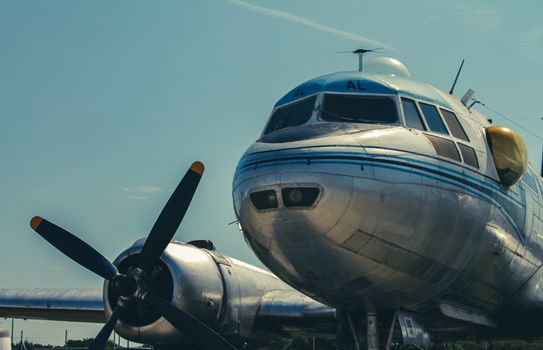 Close-up of a vintage Ilyushin Il-14 aircraft with propeller at Budapest Airport, highlighting its historical charm.