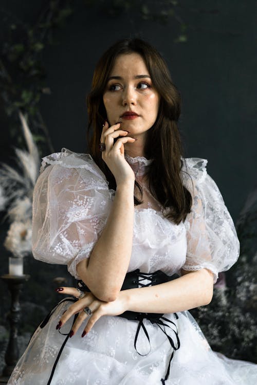 Young Brunette in a White Dress with a Black Corset 