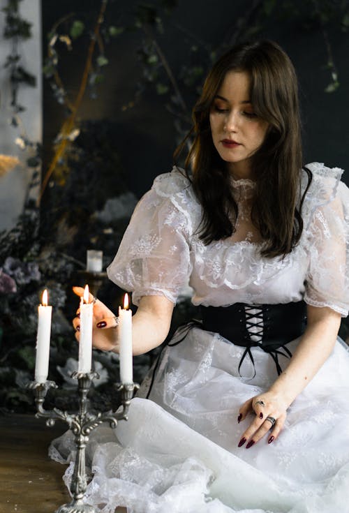 Young Woman Playing with Candle Flame