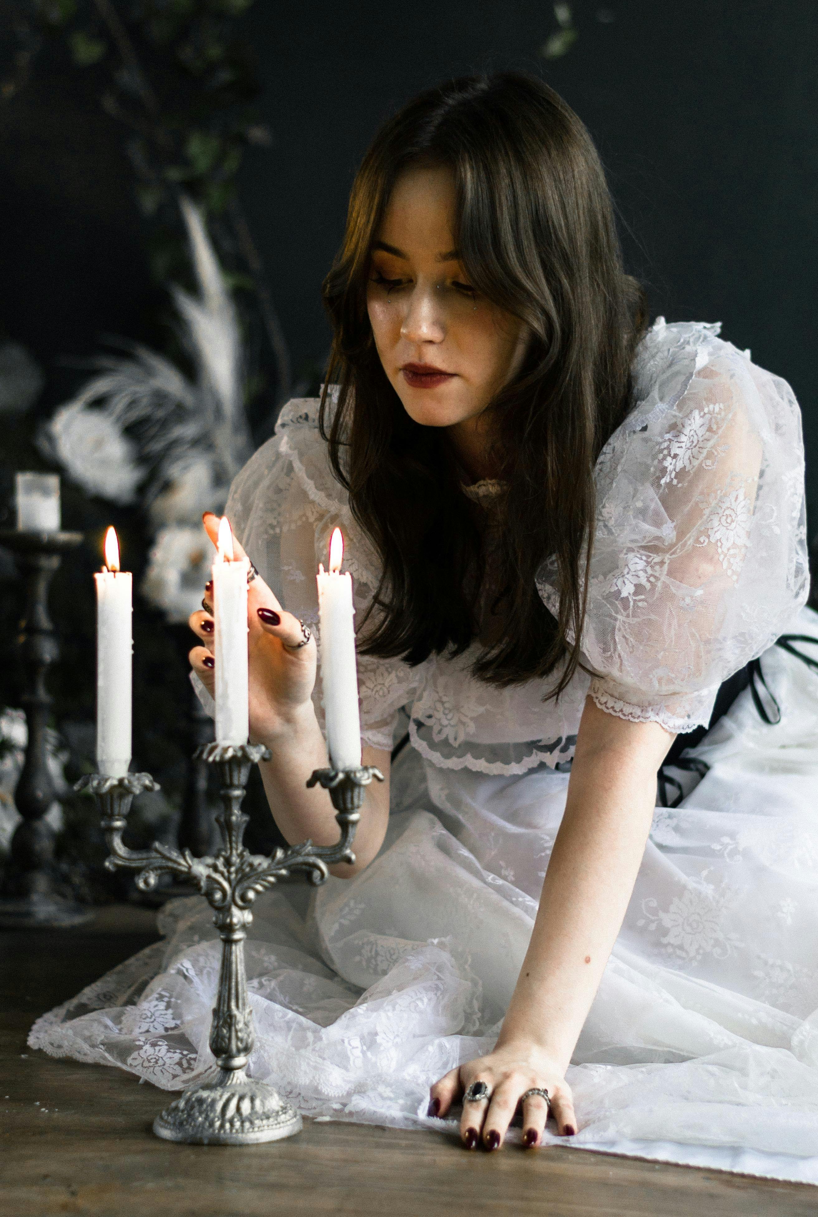 Bride with Hand over Burning Wax Candles · Free Stock Photo