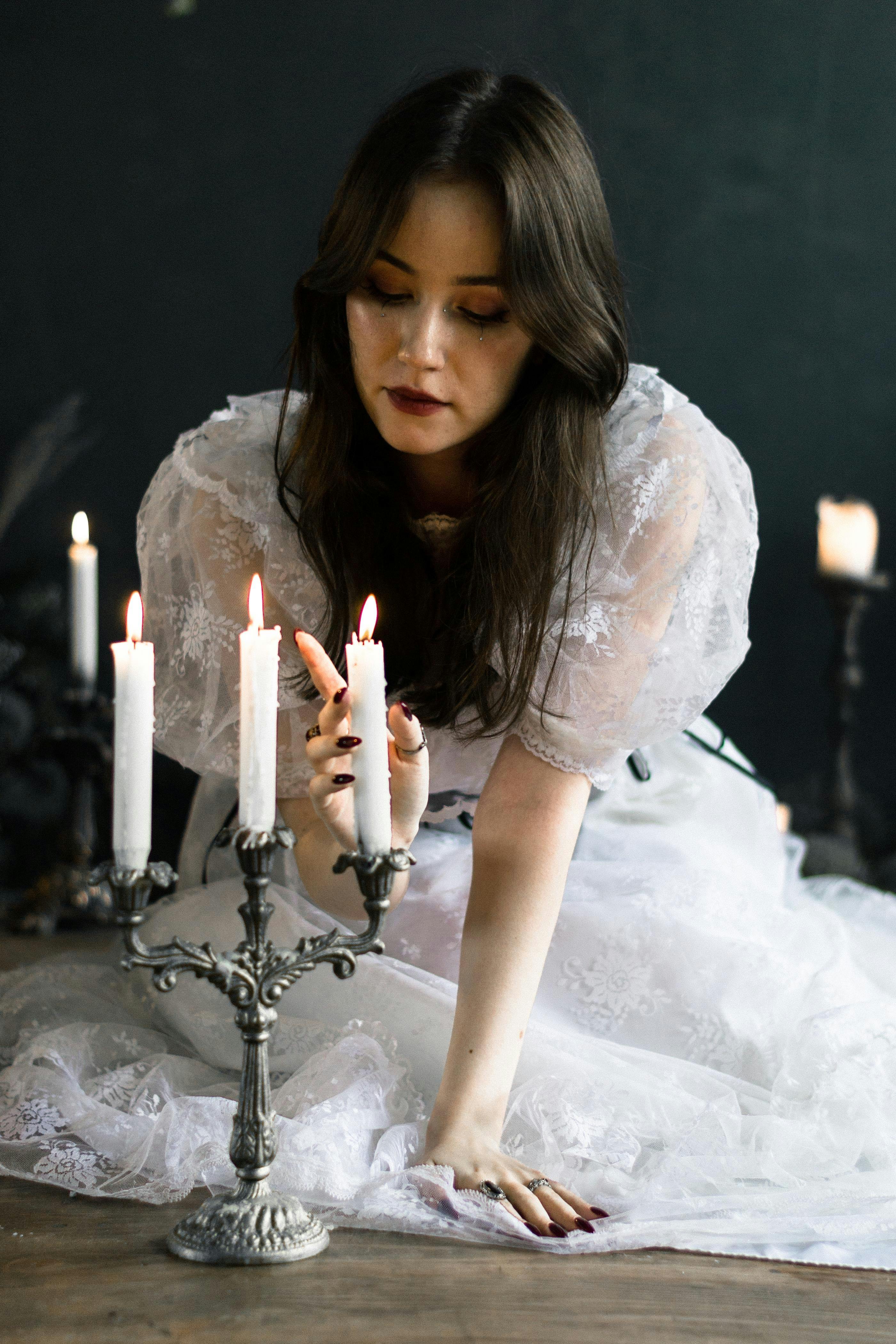 Bride with Hand over Burning Wax Candles · Free Stock Photo