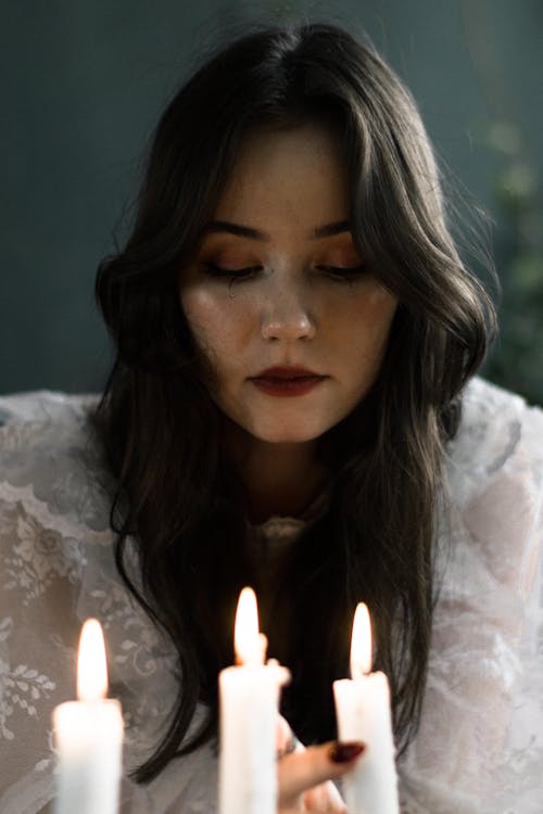 Young Woman Lighting Candles