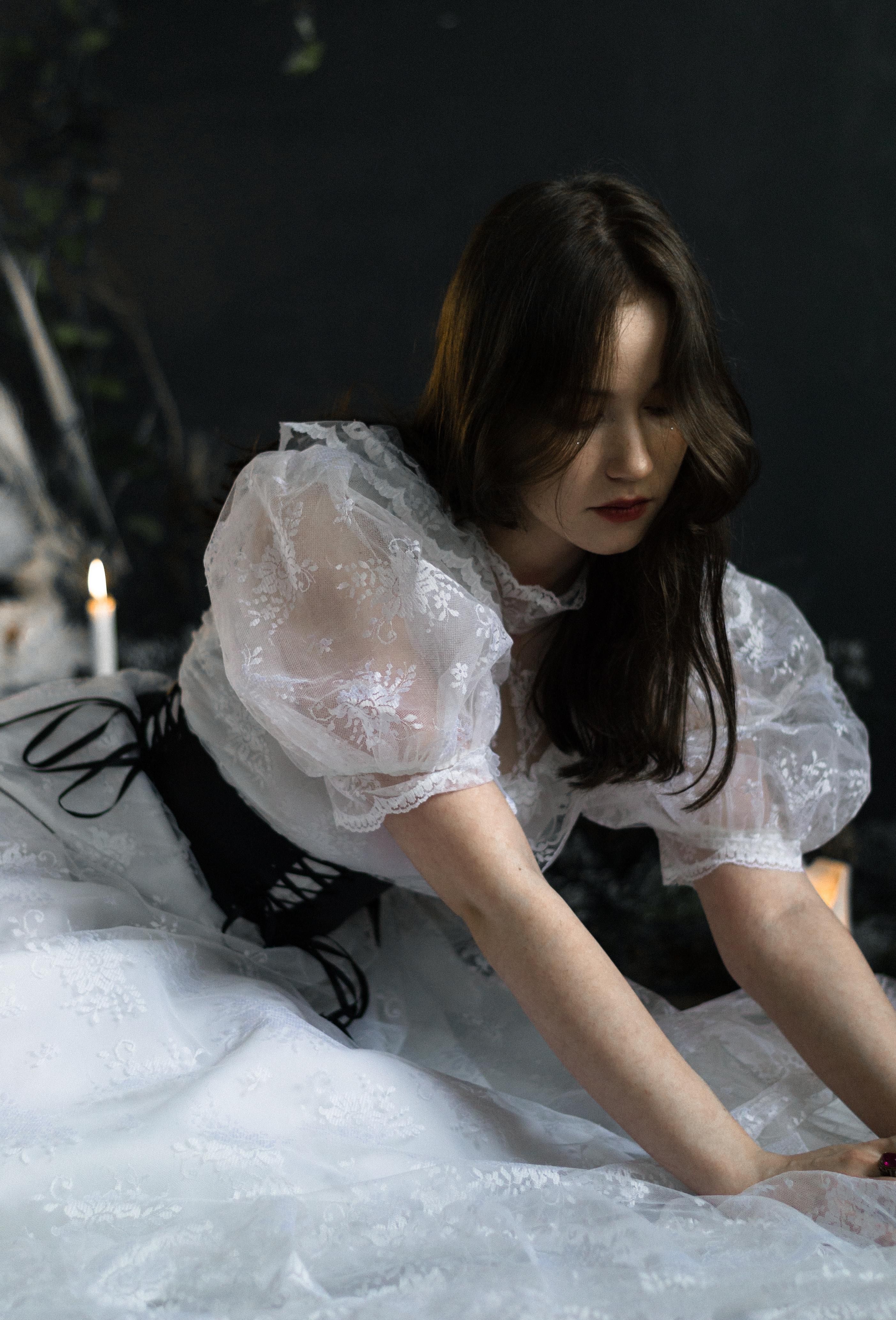 Young Brunette in a White Dress Sitting on the Floor · Free Stock Photo