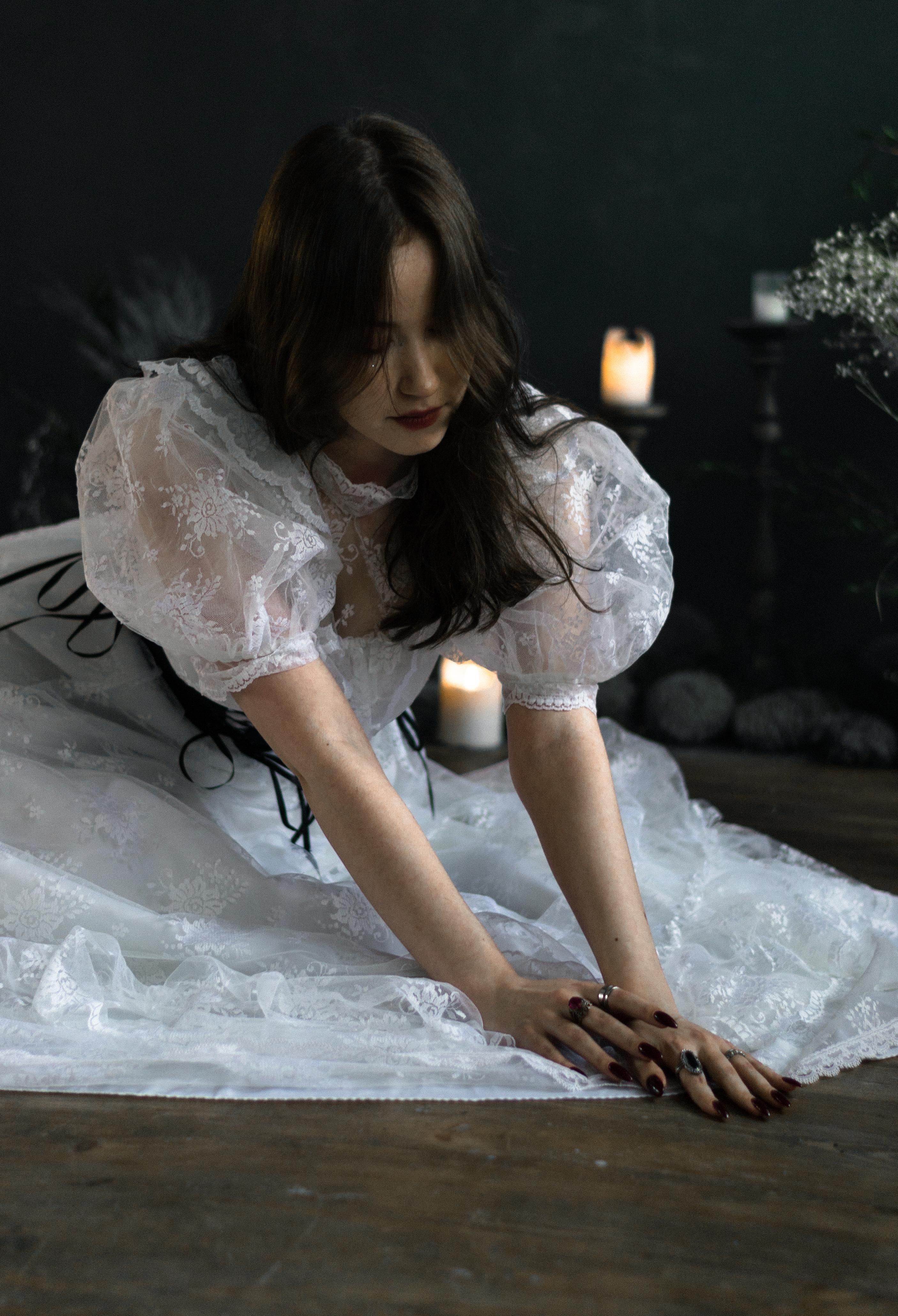 Young Brunette in a White Dress Sitting on the Floor · Free Stock Photo